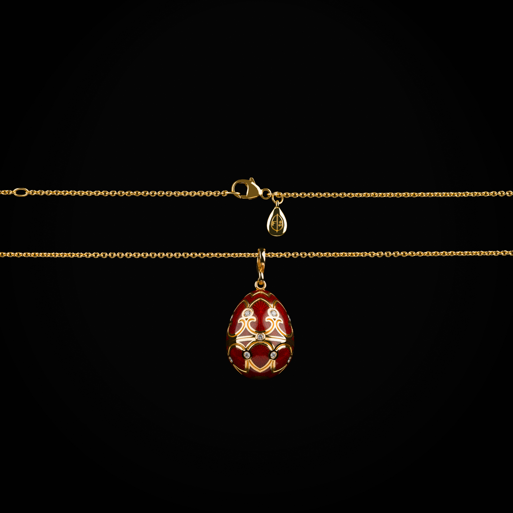 Cadena con dije huevo fabergé esmalte vitreo rojo corona interna purpura con rubís, esmeraldas, zafiros & cornalina de oro amarillo 18k