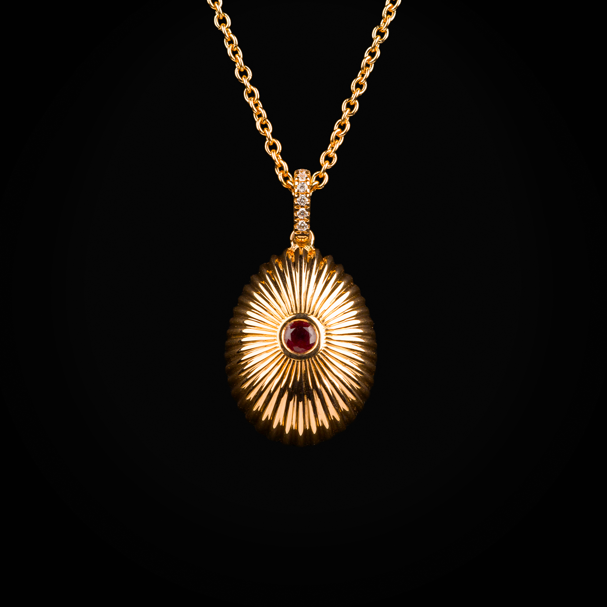 18k rose gold die-cut Fabergé egg pendant with central ruby and sapphire and brilliant-cut mine diamonds
