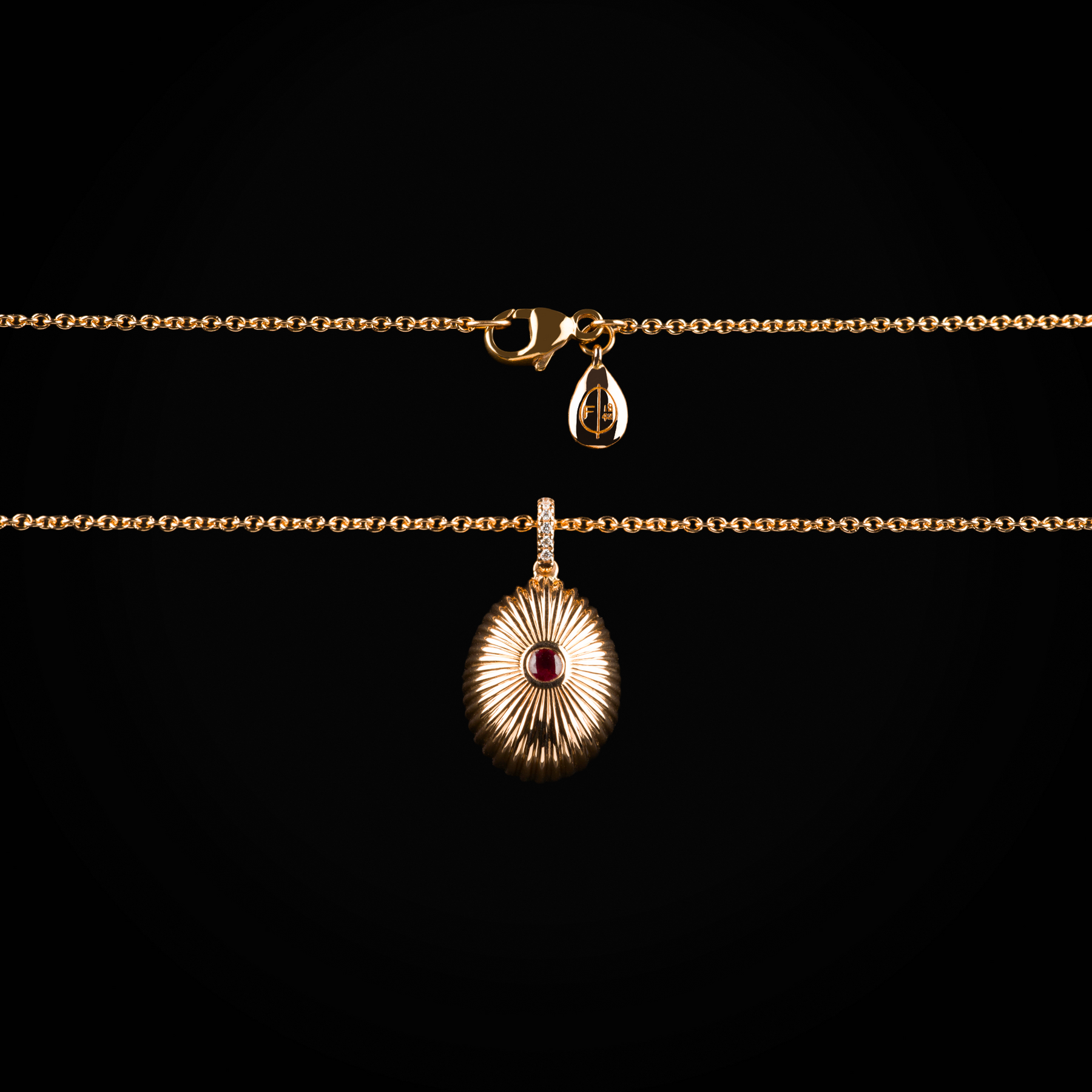 18k rose gold die-cut Fabergé egg pendant with central ruby and sapphire and brilliant-cut mine diamonds