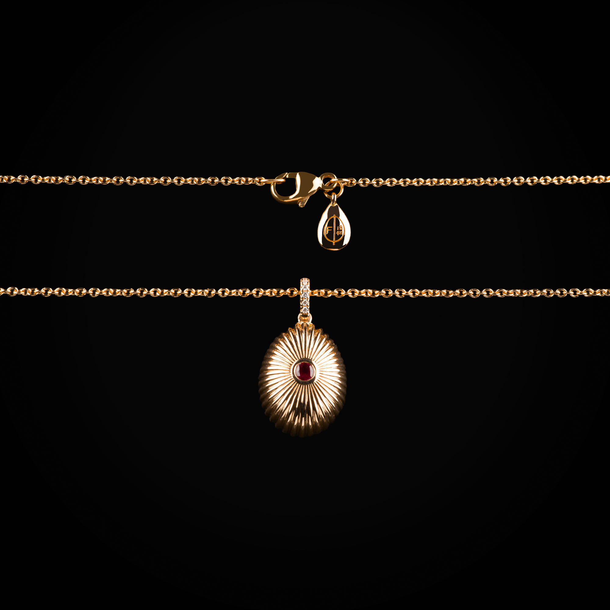 18k rose gold die-cut Fabergé egg pendant with central ruby and sapphire and brilliant-cut mine diamonds